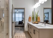 Thumbnail 5 of 38 - a bathroom with a shower and a sink and a mirror at Aura Stonebridge, Virginia, 23225