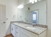 Thumbnail 8 of 40 - a bathroom with white cabinets and granite counter tops and a large mirrorat The Walker Virginia Center in Glen Allen, VA