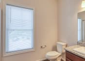 Thumbnail 33 of 35 - a bathroom with a sink toilet and a large window