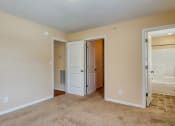 Thumbnail 10 of 21 - a bedroom with a door to a bathroom and a closet