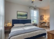 Thumbnail 25 of 53 - a bedroom with a bed and a desk with a chairat Blue Ridge Commons Apartments, Roanoke, VA, 24017