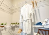 Thumbnail 24 of 53 - a white robe hanging on a rack in a closetat Blue Ridge Commons Apartments, Roanoke, 24017