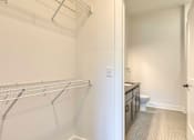 Thumbnail 10 of 29 - A white room with a metal rack on the wall at Aviator Lofts, Virginia 23602