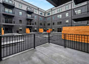 Thumbnail 11 of 27 - A black and white building with a balcony and a black fence.