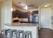 Thumbnail 40 of 60 - a kitchen with a counter top and bar stools at Proximity at ODU, Norfolk, VA, 23508