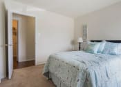 Thumbnail 25 of 52 - a bedroom with a bed and a door to a bathroom  at Bayville Apartments, Virginia, 23455
