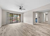 Thumbnail 37 of 52 - an empty living room with a sliding glass door to a balcony at Bayville Apartments, Virginia Beach