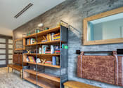 Thumbnail 22 of 35 - A room with a bookshelf and a mirror on the wall.