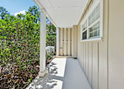 Thumbnail 67 of 77 - A white porch with a white railing and a white window.