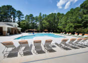 Thumbnail 12 of 57 - Swimming Pool with Lounge Chairs at Shellbrook Apartments in Raleigh NC