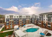 Thumbnail 24 of 42 - an aerial view of an apartment building with a swimming pool at The Bella at Westchester, Midlothian, VA