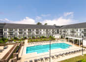 Thumbnail 51 of 81 - a large swimming pool in front of an apartment building at Ainsworth, Richmond, Virginia