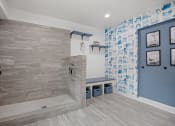 Thumbnail 3 of 22 - a bathroom with a shower and a bench and blue walls