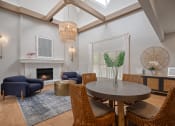 Thumbnail 1 of 22 - a living room with a table and chairs and a fireplace