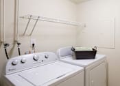 Thumbnail 26 of 36 - A white Whirlpool washing machine and dryer in a small laundry room.