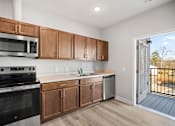 Thumbnail 3 of 31 - A kitchen with wooden cabinets and a black oven.