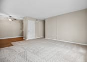 Thumbnail 32 of 33 - an empty living room with a closet and a ceiling fan