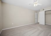Thumbnail 33 of 33 - an empty living room with a closet and a ceiling fan