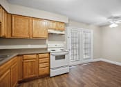 Thumbnail 24 of 33 - the preserve at ballantyne commons apartment kitchen with white appliances and wooden cabinets