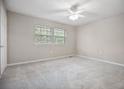 Thumbnail 27 of 33 - an empty living room with a ceiling fan and a window