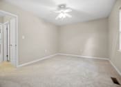 Thumbnail 28 of 33 - an empty room with a ceiling fan and a door to a closet