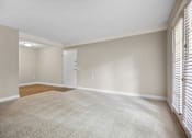 Thumbnail 16 of 33 - an empty living room with blinds on the window