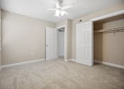 Thumbnail 20 of 33 - an empty bedroom with a closet and a ceiling fan