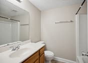 Thumbnail 18 of 33 - the preserve at ballantyne commons apartment bathroom with sink toilet and shower
