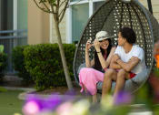 Thumbnail 9 of 60 - two people sitting on a swing in a garden at Proximity at ODU in VA 23508