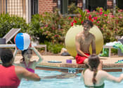 Thumbnail 3 of 60 - a group of people playing volleyball in the pool at Proximity at ODU in Norfolk, Virginia