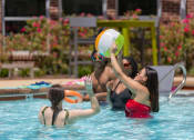 Thumbnail 5 of 60 - three women in a swimming pool playing with a volleyball at Proximity at ODU in Norfolk, Virginia 23508