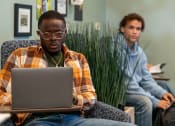 Thumbnail 17 of 60 - two persons siting, looking at a laptop at Proximity at ODU in Norfolk, Virginia 23508