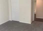 Thumbnail 60 of 78 - an empty living room with white walls and a door
