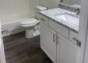 Thumbnail 78 of 78 - a bathroom with a toilet and a sink and a bath tub