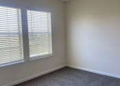 Thumbnail 47 of 78 - an empty room with two windows and a carpeted floor