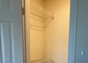 Thumbnail 55 of 78 - a walk in closet with an empty shelf and a door