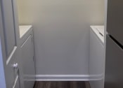 Thumbnail 53 of 78 - an empty laundry room with two washes and a dryer