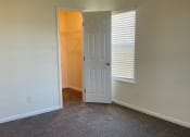 Thumbnail 49 of 78 - an empty living room with a door to a closet