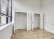 Thumbnail 15 of 46 - a bedroom with hardwood floors and white walls  at The Hudson, Virginia