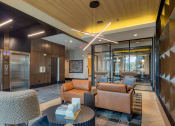 Thumbnail 22 of 38 - a lobby with couches and chairs and a tableat Aura Stonebridge, Richmond Virginia
