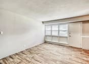 Thumbnail 3 of 24 - an empty living room with a window and a door at Gates of West Bay, Virginia