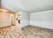 Thumbnail 4 of 24 - an empty living room with white walls and wood flooring at Gates of West Bay, Virginia, 23503