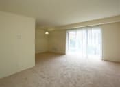 Thumbnail 10 of 24 - an empty living room with a sliding glass door to a patio at Gates of West Bay, Virginia
