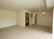 Thumbnail 12 of 24 - an empty living room and a kitchen in a house at Gates of West Bay, Norfolk, VA 23503
