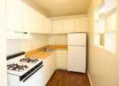 Thumbnail 9 of 24 - a kitchen with white appliances and white cabinets at Gates of West Bay, Norfolk