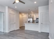 Thumbnail 23 of 47 - an empty living room and kitchen with a ceiling fan at The Port at East Beach Apartments and Marina, Norkfolk, 23518