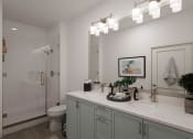 Thumbnail 21 of 47 - a bathroom with a sink and a shower and a toilet at The Port at East Beach Apartments and Marina, Virginia