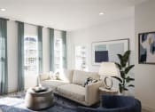 Thumbnail 17 of 47 - a living room with a couch and a table at The Port at East Beach Apartments and Marina, Virginia, 23518