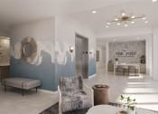 Thumbnail 15 of 47 - a lobby with a chair and a table at The Port at East Beach Apartments and Marina, Virginia