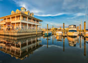 Thumbnail 6 of 47 - Longboards restaurant and boats docked at marina at The Port at East Beach Apartments and Marina, Virginia